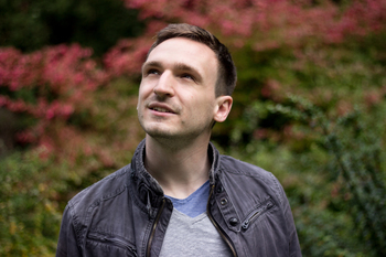 Portrait of Kilian Evang against a backdrop of autumn leaves